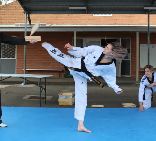 Jade showing a great reverse kick - breaking a board being held by only one hand